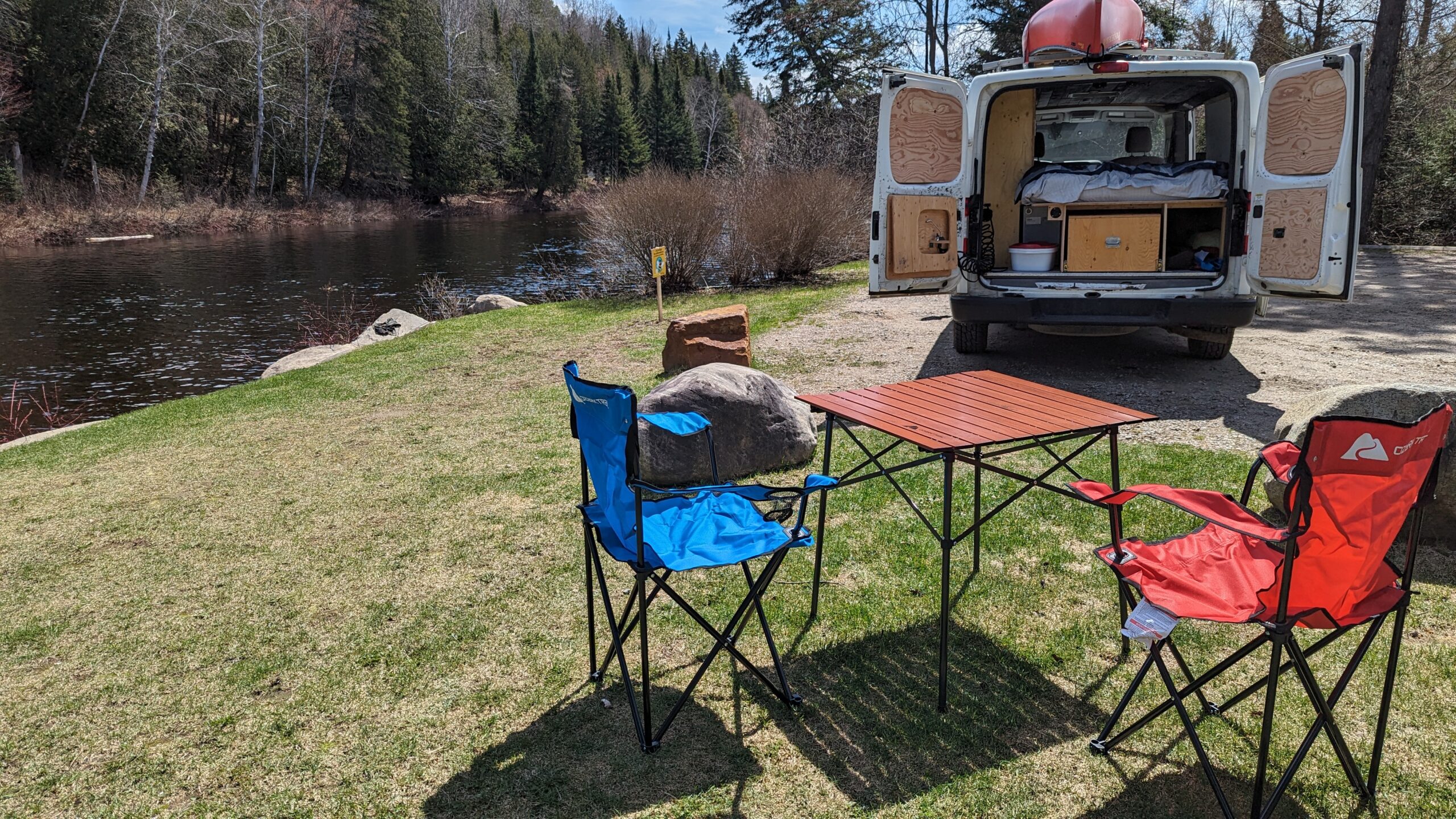 Two folding chairs and one table